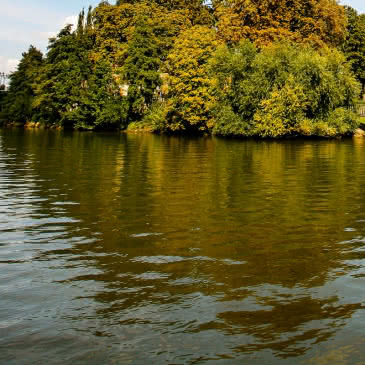 Photo de l'Isle Adam et de ses îles et ponts prise depuis un bateau sur l'Oise par beau temps